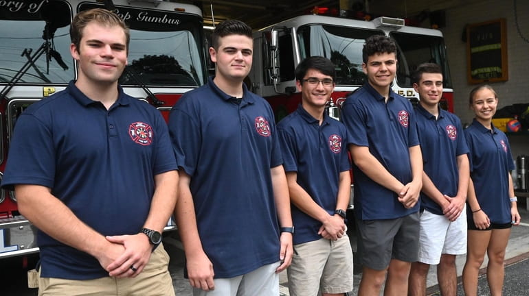 Port Jefferson firefighters, from left, Shane Hartig, 18; Ryan Parmegiani,...
