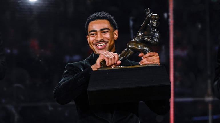 Alabama quarterback Bryce Young holds the Heisman Trophy at an...
