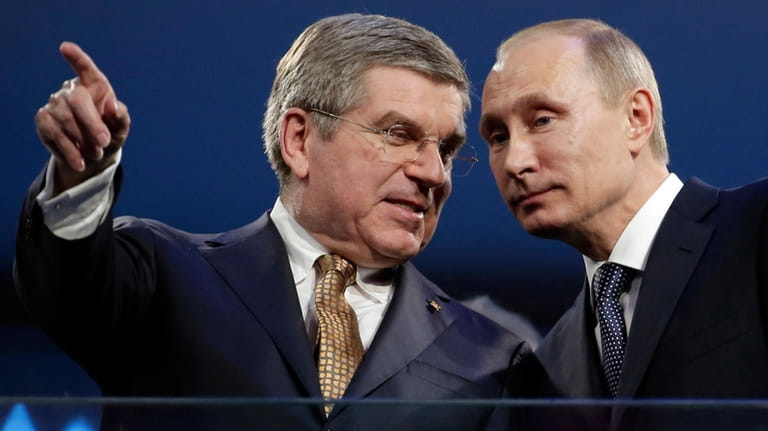 International Olympic Committee President Thomas Bach, left, and Russian President...