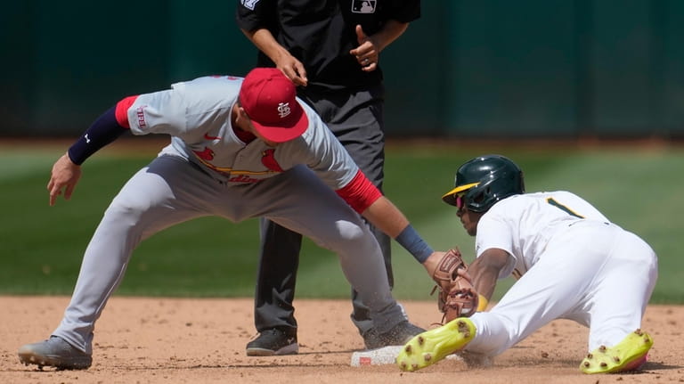 Oakland Athletics' Esteury Ruiz, right, steals second base as St....