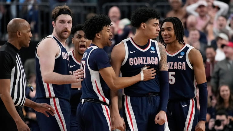 Gonzaga players celebrate during the final seconds in the second...
