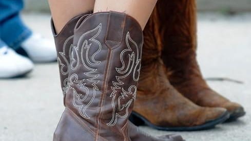 Cowboy boots are common before the Kenny CHesney concert at...