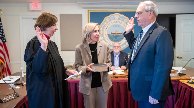 New Councilman Michael Bebon, a Democrat, takes the oath of...