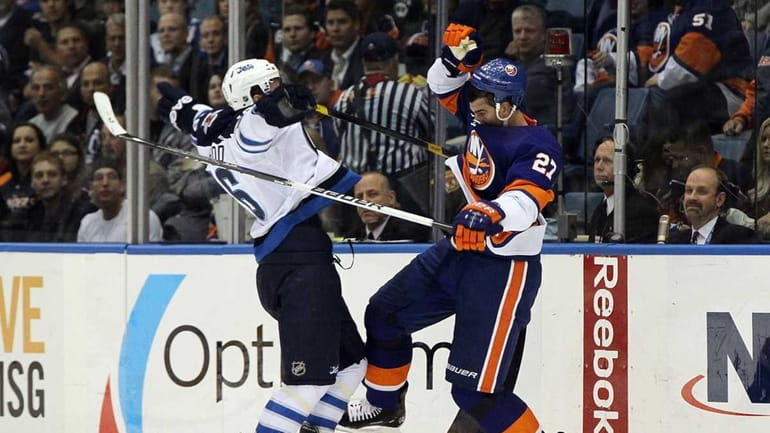 Milan Jurcina #27 of the New York Islanders collides with...