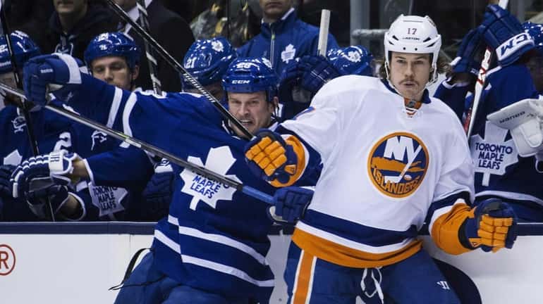 Toronto Maple Leafs' Colton Orr collides with Islanders' Matt Martin,...