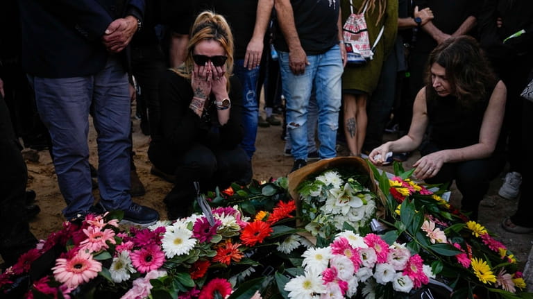 Mourners gather in grief during the funeral of Shani Gabay...