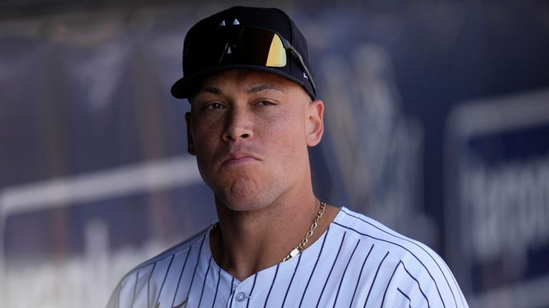 Yankees centerfielder Aaron Judge walks in the dugout before a...