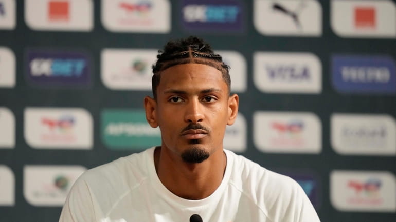 Ivory Coast's Sebastien Haller, listens to questions during a media...