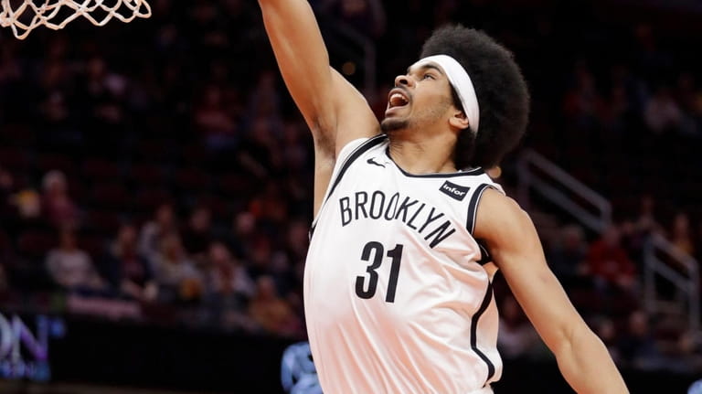 The Nets' Jarrett Allen dunks against the Cavaliers in the...