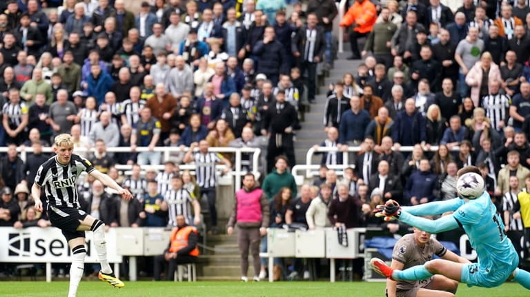 Newcastle United's Anthony Gordon, left, scores their side's second goal...
