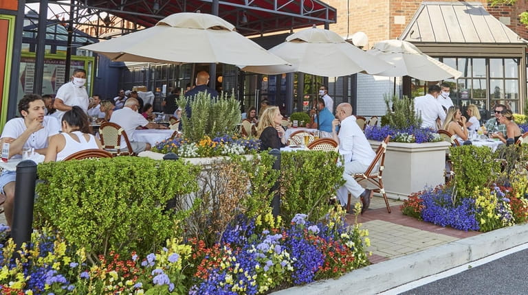 People dine outside at Bar Frites in Greenvale on June...