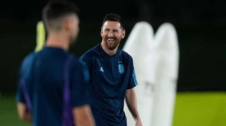 Lionel Messi jokes with teammates during a training of Argentina...
