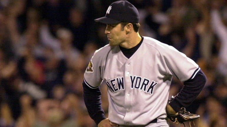 New York Yankees pitcher Mike Mussina reacts after Boston Red...