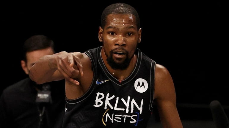Kevin Durant #7 of the Nets celebrates his three point...