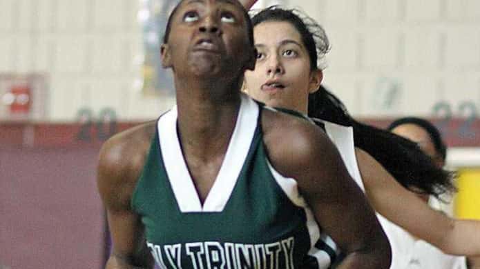 Holy Trinity's Staci Barrett gets underneath in a 61-22 win...