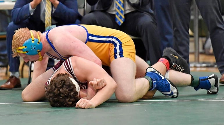 James Watterson of Kellenberg, top, gets encouragement from coaches as...