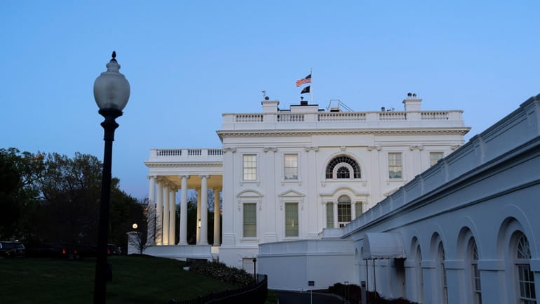 The White House is seen as dusk falls, Sunday, April...