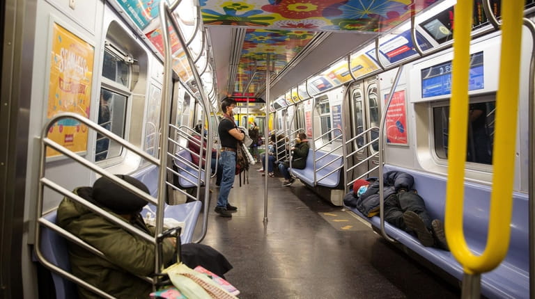 New York City subway riders wear protective masks.