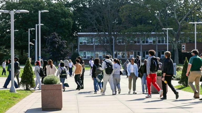 Students on the green behind the Campus Center at Farmingdale...