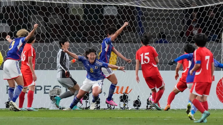 Japan's Hana Takahashi, centre, celebrates after scoring the first goal...
