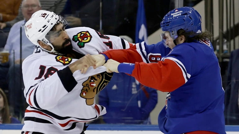 Jacob Trouba of the Rangers fights Jujhar Khaira of Chicago during the second...