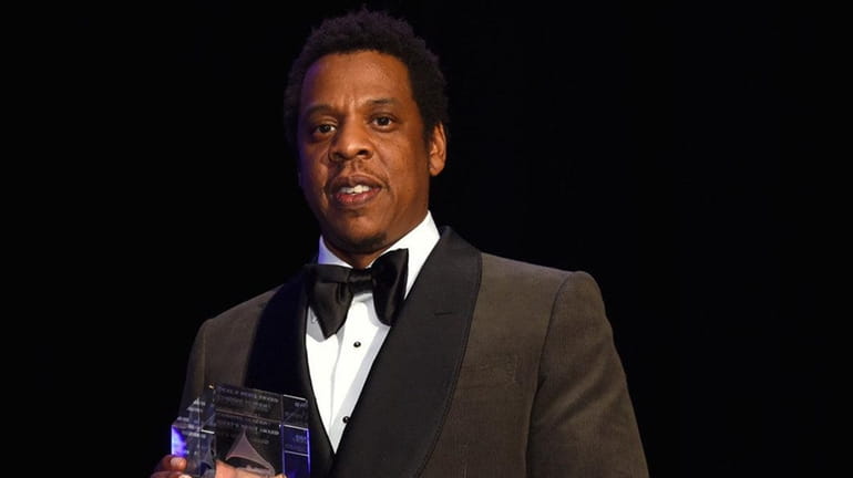 Jay-Z accepts the President's Merit Award at a pre-Grammy gala...