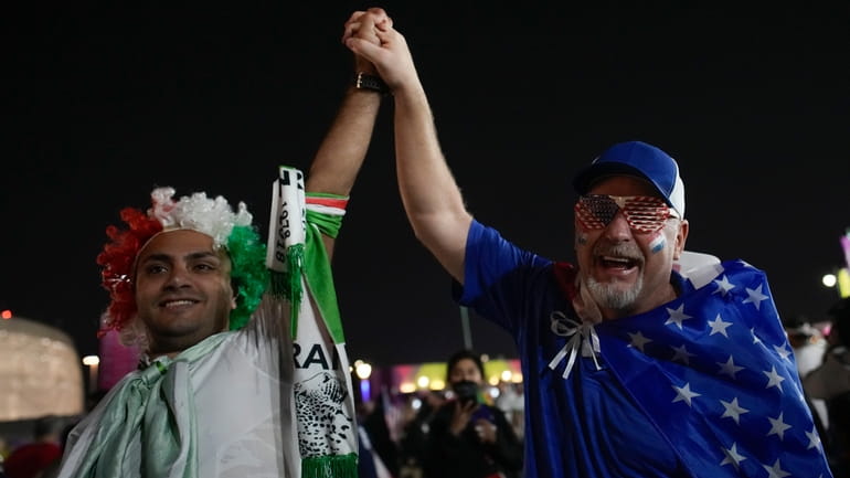 Iranian and US supporters cheer before the World Cup group...