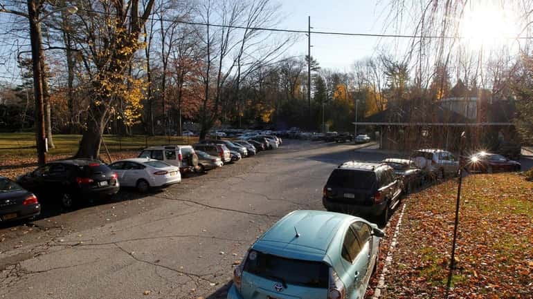 Vehicles fill the parking field at an LIRR station in...