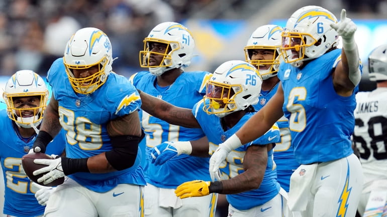 The Los Angeles Chargers celebrate a fumble recovery by defensive...