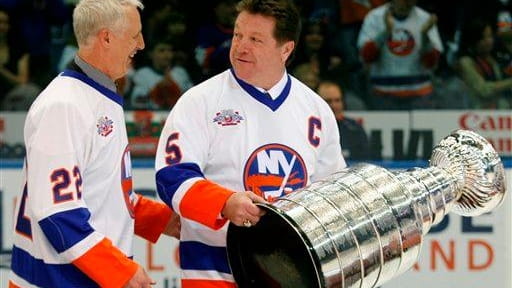 Former New York Islanders Mike Bossy, left, and captain Denis...