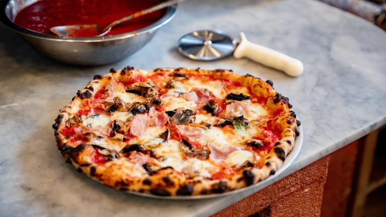 The prosciutto e funghi pizza at Chef Gigi’s Place in...