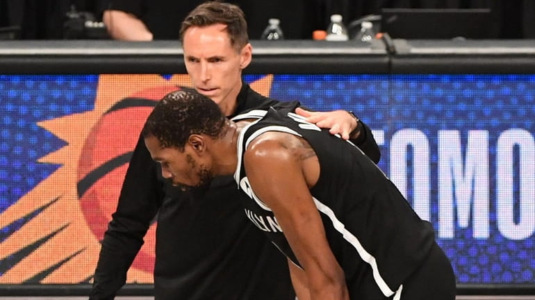 Nets head coach Steve Nash consoles Kevin Durant as the...