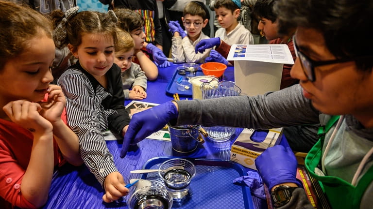 Abby Gross, and Miri Friedman participate in a science experiment...