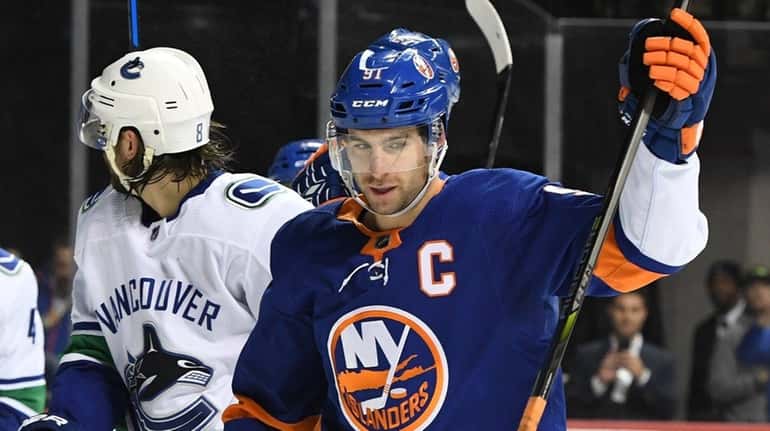 Islanders center John Tavares reacts after Anders Lee scored a...