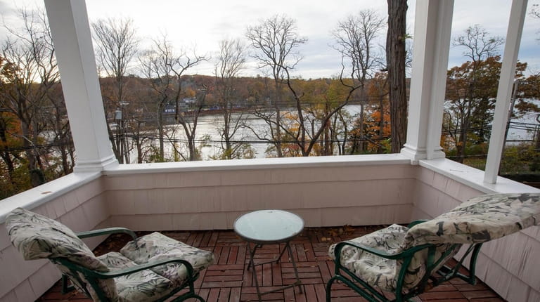 The second-floor porch of The Harbor Rose Bed & Breakfast overlooks...