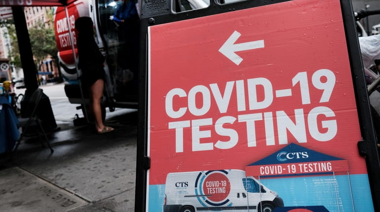  A pop-up COVID-19 testing site stands on a Manhattan street...