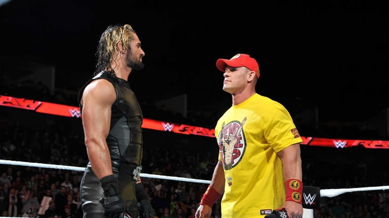 Seth Rollins, left, with John Cena, won the WWE World...