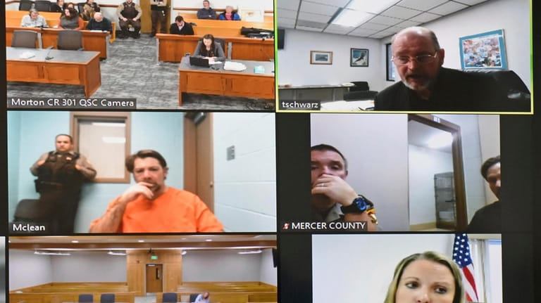 In this frame grab from video, Ian Cramer, middle left,...