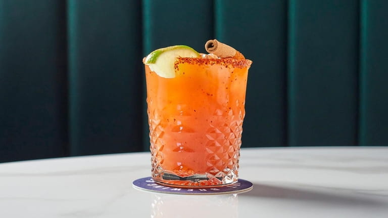 The Sandbagger cocktail with mezcal, blood orange, lime, cinnamon, simple...