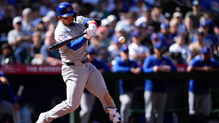 Chicago Cubs designated hitter Seiya Suzuki swings at a pitch...