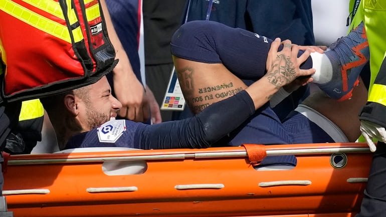 PSG's Neymar is carried off the field on a stretcher...