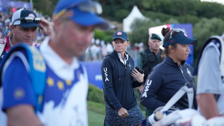 United States' Team Captain Stacy Lewis walks with her players...