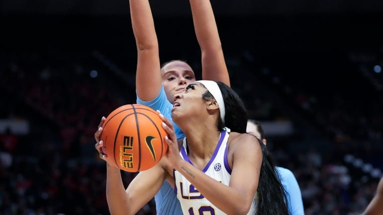 LSU forward Angel Reese (10) drives to the basket in...
