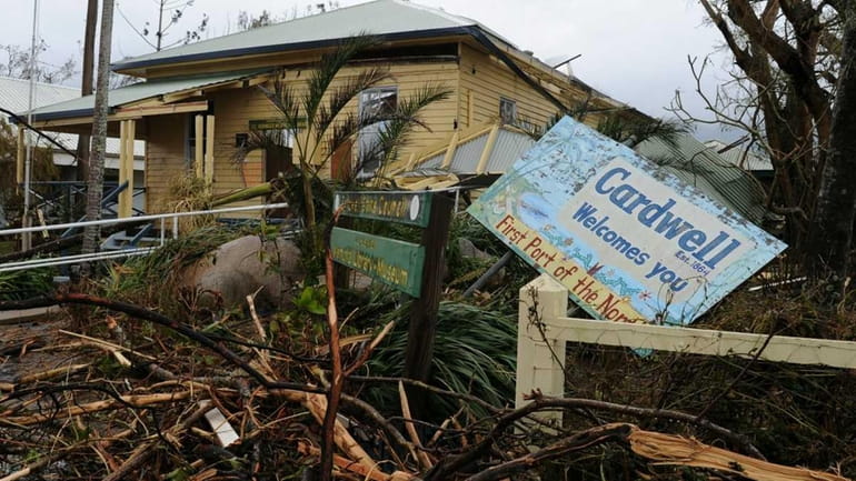 A welcome sign lies amongst wreckage in Cardwell, Australia. (Feb....