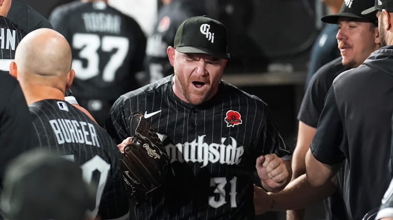 Chicago White Sox relief pitcher Liam Hendriks yells after pitching...