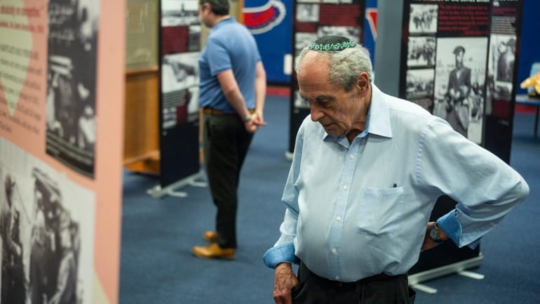 Visitors take in the Simon Wiesenthal Center's "Courage to Remember" Holocaust exhibition...