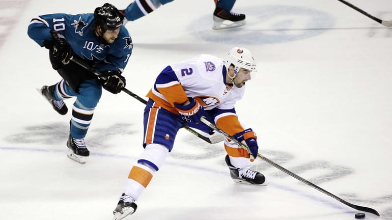Islanders' Nick Leddy is chased by San Jose Sharks' Andrew...