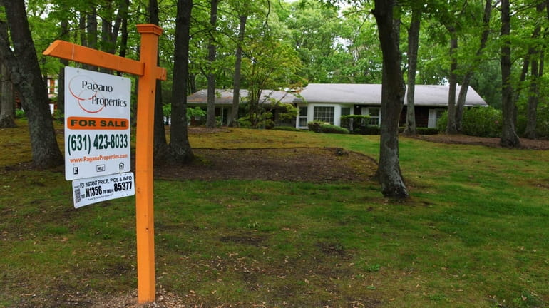 A for-sale sign on a Dix Hills property in the...