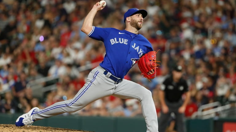 FILE -Toronto Blue Jays relief pitcher Anthony Bass throws to...