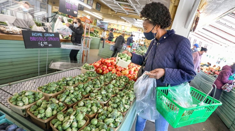 Shanee Morris, of Woodbury, looks at the Brussels sprouts during a...